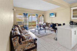 a living room with a couch and a table at Oceanview• Mins to the Beach•Private BR Balconies in Moule à Chique