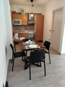 a kitchen and dining room with a table and chairs at Home 56 vacation home in Salerno