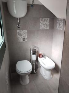 a small bathroom with a toilet and a sink at Home 56 vacation home in Salerno +3 photos