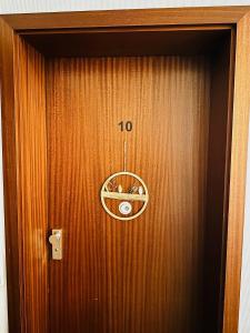 eine Holztür mit einer Uhr darauf in der Unterkunft Etagen-Wohnung nahe Flughafen Hamburg in Norderstedt + 16 Fotos