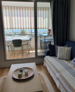a living room with a bed and a large window at Superbe vue sur mer à Sète in Sète