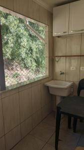 a bathroom with a sink and a window at Cobertura na Enseada a 80 m da areia in Ubatuba +42 photos