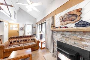 a living room with a fireplace and a couch at Hidden Valley 26 D in Mammoth Lakes
