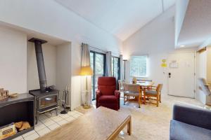 a living room with a wood stove and a table at Hidden Valley 30 D in Mammoth Lakes