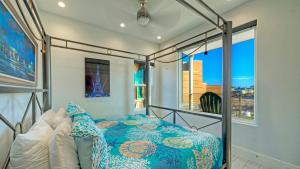 a bed in a room with a window at Modern Coastal Home w Balcony Views Firepit Prime Port A Location Casa Blanca by AvantStay in Port Aransas +38 photos