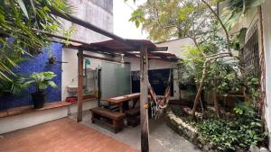a patio with a wooden table and a bench at Casa Ibirapuera - Hospedagem in Sao Paulo +19 photos