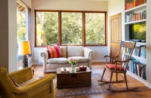 a living room with a couch and two chairs at Boyanda at Ferny Creek in Ferny Creek