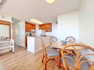 a kitchen and dining room with a table and chairs at Two Amazing Views in One Spacious Condo Getaway in Honolulu