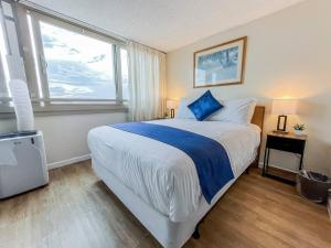 a bedroom with a large bed and a large window at Two Amazing Views in One Spacious Condo Getaway in Honolulu +35 photos
