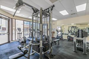 a gym with cardio equipment and treadmills at Two Amazing Views in One Spacious Condo Getaway in Honolulu