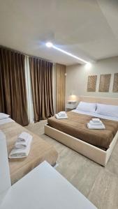 カリーニにあるMy Place B&Bのタオルが敷かれたベッドが2つある寝室