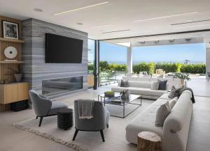a living room with a couch and a tv at Luxurious Malibu 6BR Estate with Pool, Theatre, Views in Malibu Beach