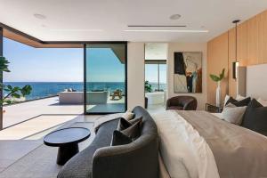 a bedroom with a bed and a view of the ocean at Luxurious Malibu 6BR Estate with Pool, Theatre, Views in Malibu Beach +52 photos