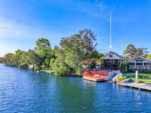 a boat is docked at a dock on a river at Dora Creek Escape with Pool and Spa in Dora Creek
