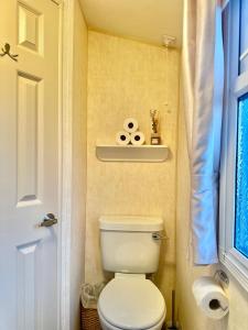 a small bathroom with a toilet and a window at East Coast in Port Seton +25 photos