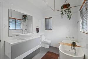 a white bathroom with a sink and a toilet at Bayview Bliss Brightwaters in Morisset East +23 photos