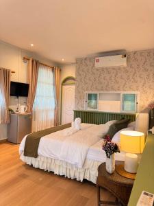 a bedroom with a large bed in a room at Our Time Staycation in Ban Chak Makham