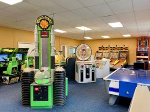 a gaming room with arcade games and a table at Loon Mountain Escape Comfortable Room Near Everything in Lincoln