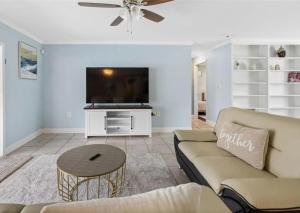 a living room with a couch and a flat screen tv at Villa W pool in Clearwater in Clearwater