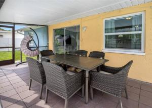 a dining room table and chairs on a patio at Villa W pool in Clearwater in Clearwater