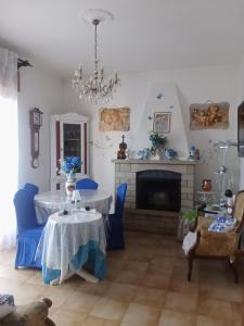 a living room with a table and a fireplace at Villa Rosa in Acqualagna