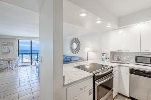 cocina con armarios blancos y vistas al océano en Beachside Two 4287, en Destin