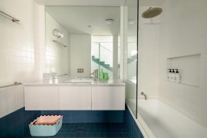 a bathroom with a sink and a tub and a shower at Chic Seddon Retreat Near the CBD in Seddon +22 photos