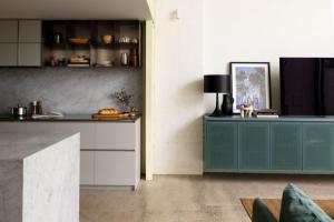 a kitchen with a blue cabinet in a room at Chic Seddon Retreat Near the CBD in Seddon
