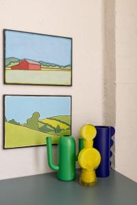 a table with vases and pictures on a wall at Chic Seddon Retreat Near the CBD in Seddon