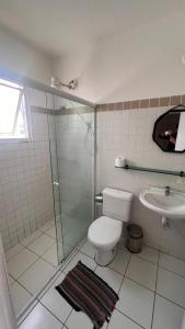 a bathroom with a shower and a toilet and a sink at Casa Ibirapuera - Hospedagem in Sao Paulo