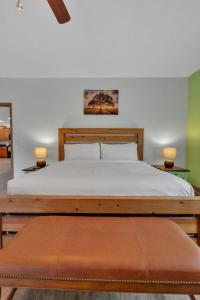 a bedroom with a large bed with two lamps at Whiskey Cove Lakefront 2 Fireplaces 2 FirePits in Baneberry