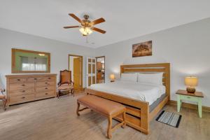 a bedroom with a bed and a ceiling fan at Whiskey Cove Lakefront 2 Fireplaces 2 FirePits in Baneberry