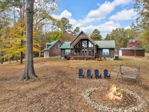 a house with a fire pit in the yard at Whiskey Cove Lakefront 2 Fireplaces 2 FirePits in Baneberry