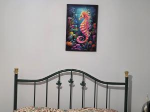 a painting of a seahorse hanging on a wall at Home away from city noise Be in Hythe