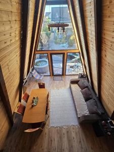 an overhead view of a living room with a large window at A Frame la Iaz in Mărăcineni