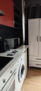 a kitchen with a washing machine on a counter at Studio propre disponible in Vigneux-sur-Seine