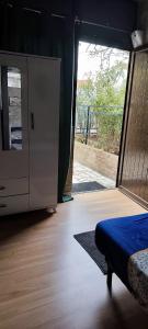 a bedroom with a bed and a sliding glass door at Studio propre disponible in Vigneux-sur-Seine