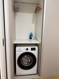 a laundry room with a washer and dryer at Veleslaveenka in Plzeň +10 photos