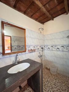 a bathroom with a sink and a mirror and a tub at Maria Paulo Guest House Bar and Restaurant in Agonda +87 photos