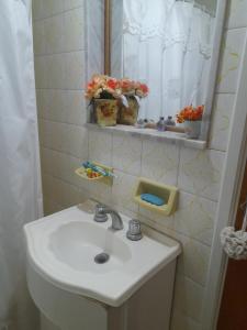 a bathroom with a sink and a mirror at La Casa de Oli in Chascomús +15 photos