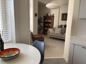 a kitchen and living room with a white table at Apartament Dominic in Sopot