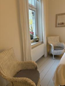 a room with two chairs and a window at Apartament Dominic in Sopot