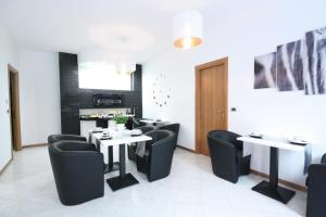 a restaurant with two tables and black chairs at Black and White in Cantù