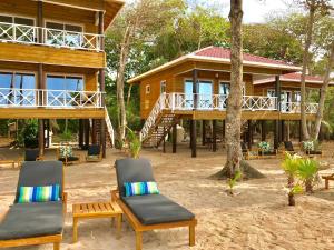 een resort met twee stoelen en een huis bij Turtle Beach Sanctuary, Utila in Utila