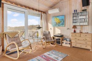 a living room with two chairs and a window at TV1694-Bindslev-Musvagevej-8 in Tversted