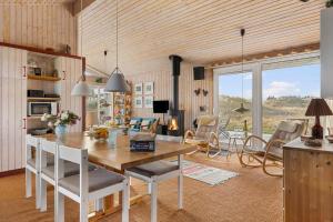 a kitchen and living room with a table and chairs at TV1694-Bindslev-Musvagevej-8 in Tversted