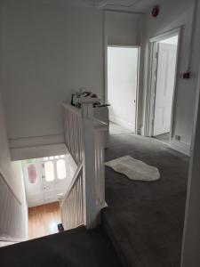 an empty room with a staircase and a door at Victorian House with 4 Bedrooms 9 Beds 13 Guests 2 Bathrooms Parking in Caversham