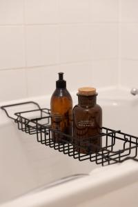 two bottles sitting in a wire basket on a refrigerator at Charming Apartment with Prime Location in Royal Tunbridge Wells