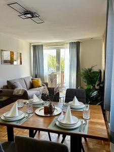 a living room with a table and a couch at Wallersee Retreat in Neumarkt am Wallersee