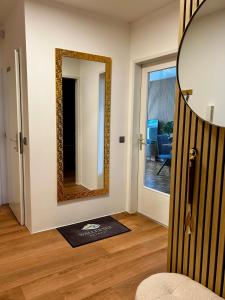a mirror on a wall next to a room at Wallersee Retreat in Neumarkt am Wallersee +17 photos